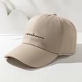 Detailed close-up of khaki cotton baseball cap with black freedom embroidery script - One Size / Khaki