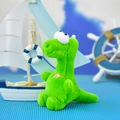 Close-up of a cute green plush dinosaur keychain with a nautical background decor - 14cm / Green