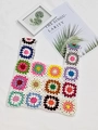 Flat lay of colorful crochet granny square tote bag with intricate floral patterns - White