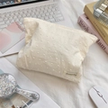 Close-up of beige polka dot cosmetic bag with fabric brand label on a cozy desktop - Yellow Polka Dot