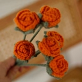 Handcrafted crochet bouquet featuring orange knitted flowers and green yarn stems - Single Finished Flower / Bubble Rose (Orange)