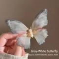Detail view of ethereal grey-white tulle butterfly hair clip with pearl accents and veined wings - With Hair Clip / Grey/White