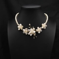 Baroque petal necklace featuring freshwater pearls and gold accents on a black bust - Exaggerated 5 Flowers