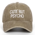 Close-up of 'CUTE BUT PSYCHO' white embroidery on washed cotton baseball cap - One Size / Khaki