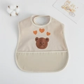 Waterproof baby wing bib in beige with cartoon bear and heart prints and a crumb catcher - Pu Bib (double Layer) - Three Hearts Bear / One Size