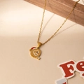 Detail of gold stainless steel necklace with enamel Christmas puppy pendant and festive props - Santa Letter Q