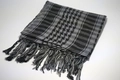 Detailed view of the woven cotton texture and fringe on the plaid desert scarf - Gray