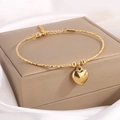 Bracelet doré en acier titane avec pendentif coeur et chaîne ajustable sur soie - Petit Cœur Or