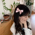 Pink satin bow hair clip with heart rhinestone accent worn on a model's side hair - Rhinestone Heart Satin Bow Hair Clip 1PC