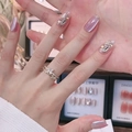 Detail of pink cat-eye press-on nails with butterfly ring and shell decorations - By1621 Has Beautiful Features / Glue Type