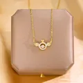Elegant gold angel wing crown necklace with a moving dancing stone pendant on a gift box - Gold Dancing Wings (Style 2)
