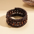 Detailed view of multilayer coconut shell and brown wood beads on an ethnic retro bracelet - Coffee - Round Style