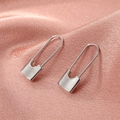 Minimalist silver paperclip earrings on pink silk, 45-degree angle professional close-up - Silver Pin Earrings (wg-0672)