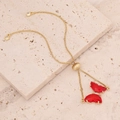 18K gold butterfly bracelet with red gemstones and crystals on marble surface - Red