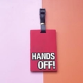 Red PVC luggage tag with Hands Off slogan and black adjustable strap on colorful background - HANDS OFF Slogan / Red