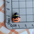 Miniature orange pumpkin charm with black wizard hat shown on grid ruler for scale - Orange Pumpkin with Black Hat