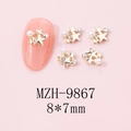 Close-up of golden star nail charms with pearls and rhinestones on pink manicured nails - MZH-9867 (8*7mm)