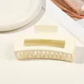 Detail of a large matte cream hair claw clip with a hollow rectangular design on a white plate - 10.5cm Rectangular - Macaron Milky White