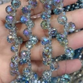 Macro shot of 6-8mm faceted aurora crystal glass beads with AB coating for jewelry - Transparent Green