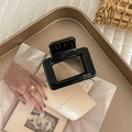 Detail of square black acetate hair claw with gold lettering on a vintage tray - Square / Black