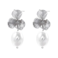 Close-up of elegant silver flower stud earrings with white oval pearls on white background - Silver