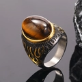 Macro view of men's punk ring with tiger eye stone and golden flame patterns - Two-tone Tiger Eye