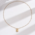 Elegant gold bead chain necklace with white shell lock pendant on white background - Lock Pendant / Gold