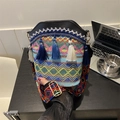 Bohemian knit bucket bag featuring colorful tassels and wide woven geometric shoulder strap - Black