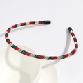 Detailed view of red and green rhinestone headband with protective black tips on ends - Single Row Rhinestone Headband