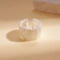 Macro detail of the silver geometric open ring featuring a unique lava texture finish - Silver