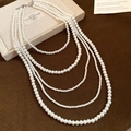 Elegant multi-layered vintage white pearl necklace with silver clasp on jewelry box - Necklace-Pearl Style / White
