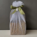 Detail of woven seagrass gift basket with olive green ribbon and gold star mesh wrap - Moss Green Full Wrap Star Moon Mesh
