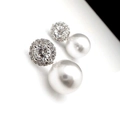 Macro shot of micro-paved zircon stud earrings with high-luster round white pearls - White Gold