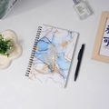A5 spiral notebook with blue marble cover design and black metal coil on a desk - Blue White Marble Pattern (80 Sheets)