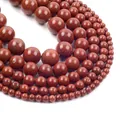 Detailed view of red jasper round beads in various sizes arranged in a spiral pattern - Imported Red Stone