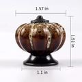 Brown pumpkin ceramic drawer knob with dimensions 1.57 x 1.51 inch and bronze metal base - Leopard White