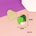 Detail view of monstera plant enamel pendant showing front design and textured back - No.5 Banana Leaf