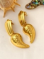 Detailed view of vintage gold geometric earrings on a neutral textured fabric - Textured Teardrop Pendant