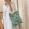 Detail of green floral canvas tote bag with rabbit illustration and white label - Green Rabbit