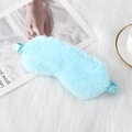 Light blue plush sleep mask with elastic strap on white faux fur background - Sky Blue