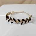 Macro shot of a vintage gold mesh headband decorated with black marquise cut gemstones - Navette Black Style