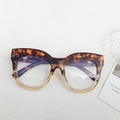 Retro cat-eye glasses with tortoise shell frame and metal rivet details on white background - Flower Top Champagne Bottom