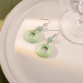 Macro shot of green faux jade beaded earrings with silver hooks on a decorative plate - E5616-2/Translucent Jade Ring