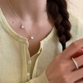 Silver heart pendant necklace with pearl detail and slim sparkling ring on a model - Heart Pearl Layered Style (XL2220)