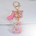 Pink resin letter S keychain with butterfly sequins and a soft faux suede tassel - Letter S