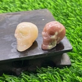 Mini natural crystal skulls in rose quartz and bloodstone finish on wood base - Rhodonite