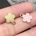 Pink sakura flower alloy pendant with golden edges showing front and back detail - 1Pc Pink Small Cherry Blossom 12x14.5mm