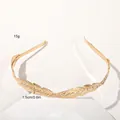Detailed macro view showing the textured golden leaf pattern and metal finish of the headband - Metal Headband-Two Leaves