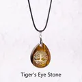 Tiger Eye teardrop pendant with golden Tree of Life engraving on a black wax cord - Tree of Life Tiger Eye Pendant