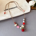 Handmade woven necklace with colorful beads and apple pendant on soft grey background - Red White Green Square Button Apple Pendant Necklace